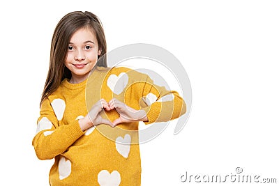 Studio portrait of a little girl on white background making a heart gesture with her hands. Fostering a child. Stock Photo