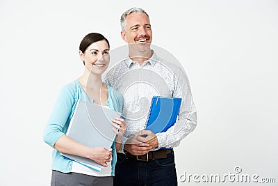 Studio Portrait Of Male And Female Pre School Teachers Stock Photo