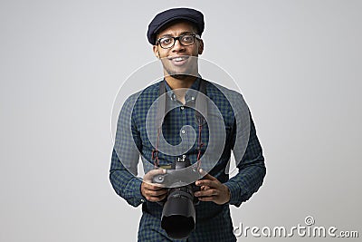 Studio Portrait Of Male Photographer With Camera Stock Photo