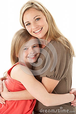 Studio Portrait Of Mother Hugging Young Daughter Stock Photo
