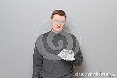 Portrait of proud confident man stretching out his hand with money Stock Photo