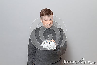 Portrait of proud confident man stretching out his hand with money Stock Photo