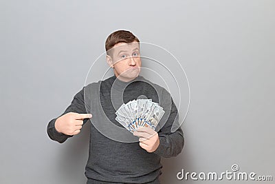 Portrait of proud confident mature man pointing at money Stock Photo