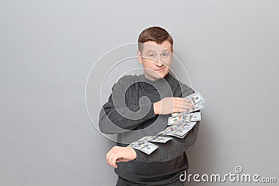 Portrait of proud confident blond mature man boasting of his money Stock Photo