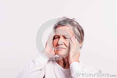 Studio portrait of a senior woman in pain. Stock Photo