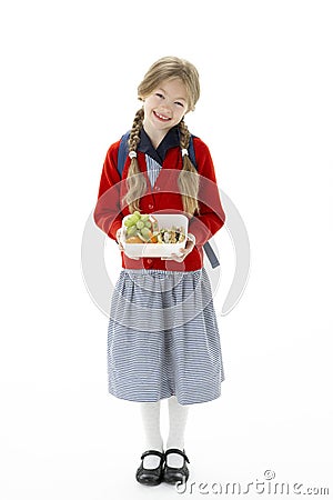 Studio Portrait of Smiling Girl Holding Lunchbox Stock Photo