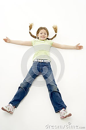 Studio Portrait of Smiling Girl lying down with ar Stock Photo