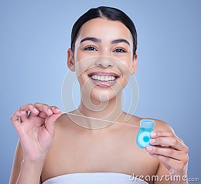 Studio portrait of a smiling mixed race young woman with glowing skin posing against blue copyspace background while Stock Photo