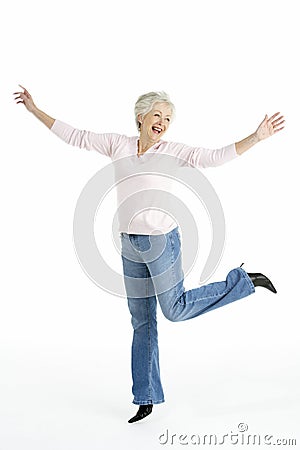 Studio Portrait Of Smiling Senior Woman Stock Photo