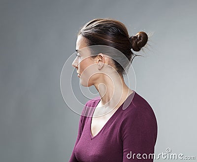 Studio portrait of a thinking 30s woman, profile view Stock Photo