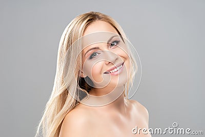 Studio portrait of young, beautiful and natural blond woman over grey background. Face lifting, plastic surgery Stock Photo