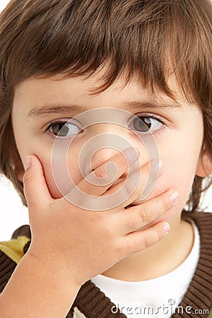 Studio Portrait Of Young Boy Looking Guilty Stock Photo