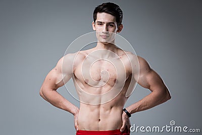 Studio portrait of a young brunette caucasian man on gray background posing. Puberty theme, problem skin, teen acne Stock Photo