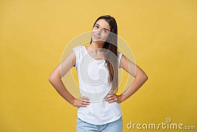 Studio shot of attractive self confident young female in great mood feeling happy, holding hands on her slender waist Stock Photo