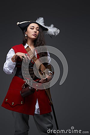 Dangerous female corsair with wavy hairs wearing costume Stock Photo