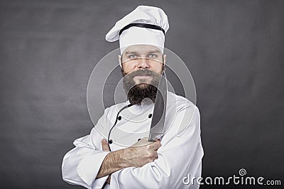 Studio shot of a bearded chef holding a big sharp knife Stock Photo