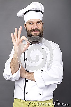 Studio shot of a bearded chef showing OK sign Stock Photo