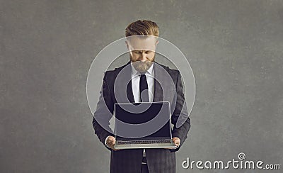 Studio shot businessman shows laptop black screen blank screen monitor for text Stock Photo