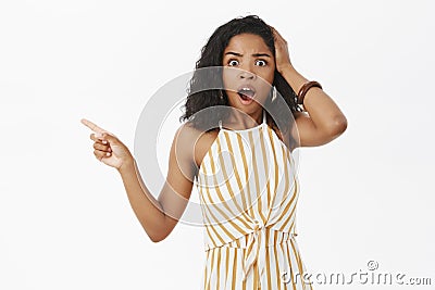 Studio shot of concerned shocked african american female entrepreneur witnessing terrible scene being speechless and Stock Photo