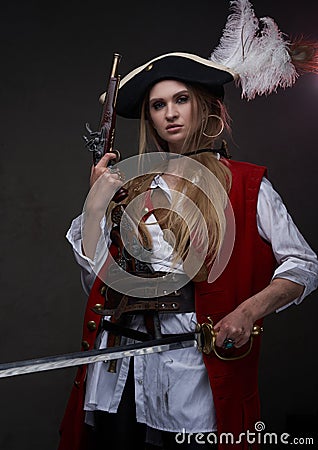 Female mercenary pirate with gun and sword Stock Photo