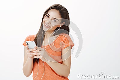 Studio shot of happy attractive caucasian female with long beautiful hair, tilting while feeling satisfaction with great Stock Photo