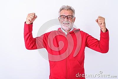 Studio shot of happy senior bearded man smiling while flexing bo Stock Photo