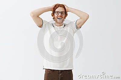 Studio shot of impressed excited and surprised attractive redhead male student being amazed and stunned with great Stock Photo