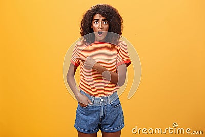 Studio shot of offended shocked stylish woman being robbed fasping and staring nervously begging stranger help out Stock Photo