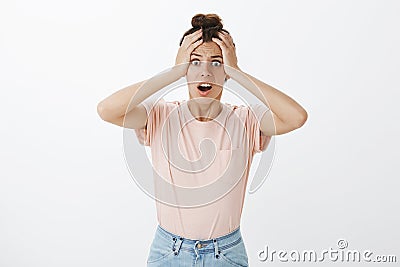 Studio shot of panicking woman realising forgot to send important email standing concerned with hands on head and opened Stock Photo