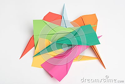 Pick a plane and lets play. Studio shot of a pile of colourful paper jets. Stock Photo