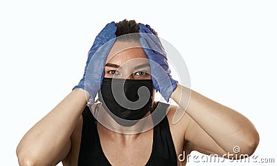 Studio shot on white background of a sick young woman wearing mask and latex gloves, stressed by quarantine Stock Photo