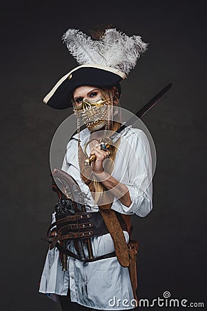 Woman pirate with golden mask and saber Stock Photo