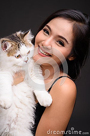 Young beautiful Asian woman holding Persian cat Stock Photo