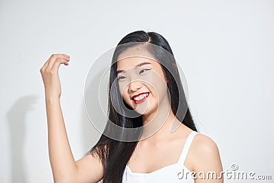 Studio shot of young charming dark haired woman with festive makeup looking thoughtfully aside Stock Photo