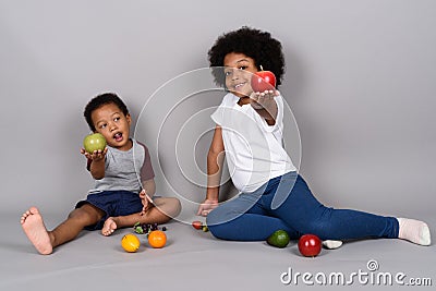 Young cute African siblings together against gray background Stock Photo