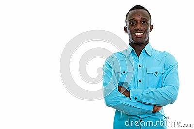 Studio shot of young happy black African man smiling with arms c Stock Photo