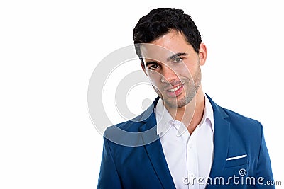 Studio shot of young happy Hispanic businessman smiling Stock Photo