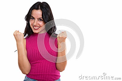 Studio shot of young happy Spanish woman smiling while looking e Stock Photo