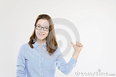 Studio shot young pretty girl pointing with thumb Stock Photo