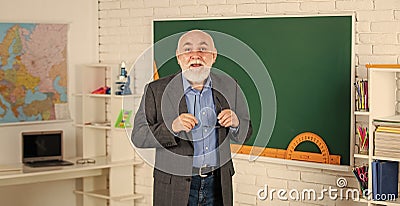 study for geography exam. lesson in classroom. learn geometry easily. become good at math. senior man teacher at Stock Photo