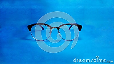 Study glasses on blue background Stock Photo