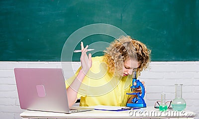 Study microbiology. Investigate molecular modifications. Microbiology concept. Student girl with laptop and microscope Stock Photo