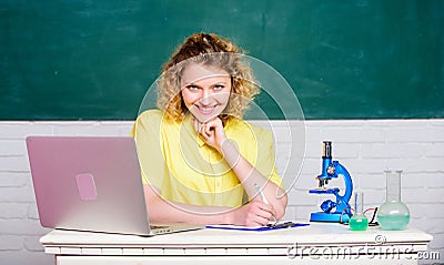 Study microbiology. Investigate molecular modifications. Scientific research. Student girl with laptop and microscope Stock Photo