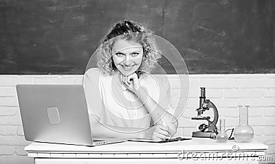Study microbiology. Investigate molecular modifications. Scientific research. Student girl with laptop and microscope Stock Photo