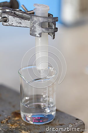 Separating by filtration and evaporation condensation the component substances from liquid mixture in Lab. Stock Photo