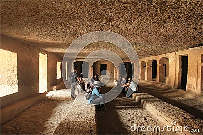 Studying Buddhist caves Editorial Stock Photo