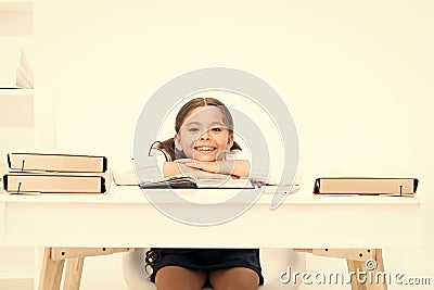 Studying on desk with incorrect height can lead back pain. What should be height of study table. Schoolgirl doing Stock Photo