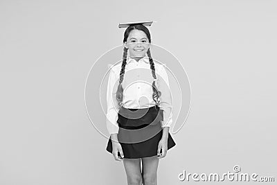 Studying hard. small girl child with book on head. back to school. reading and writing. literature lesson. childrens Stock Photo