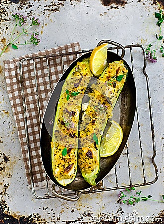 The stuffed, baked zucchinis from a quinoa , bulgury and feta. Stock Photo