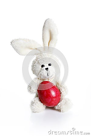 Stuffed easter bunny with red egg Stock Photo